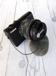 Camera Lens Cap Leash with Boot Prints - Riveted Oak Designs